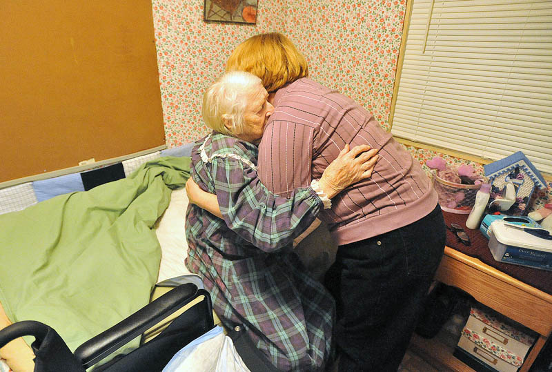 Staff photo by Michael G. Seamans Cheryl helps her mother to bed at the end of the day on December 8, 2011.