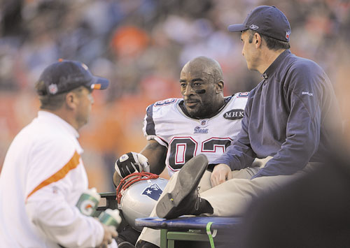 CARTED OFF: New England Patriots defensive end Andre Carter is carted off the field after an injury in the second quarter against the Denver Broncos on Sunday in Denver.
