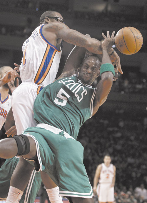 TOUGH GUYS: New York Knicks forward Amare Stoudemire, left, gets tangled up with Boston Celtics power forward Kevin Garnett (5) in the first half Sunday at Madison Square Garden in New York.