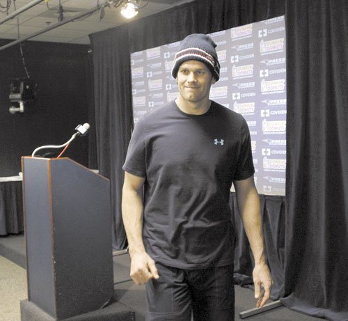 IN OR OUT: New England Patriots quarterback Tom Brady leaves the podium after a press conference Wednesday in Foxborough, Mass. Brady participated in practice on a limited basis Thursday amid reports of a shoulder injury.