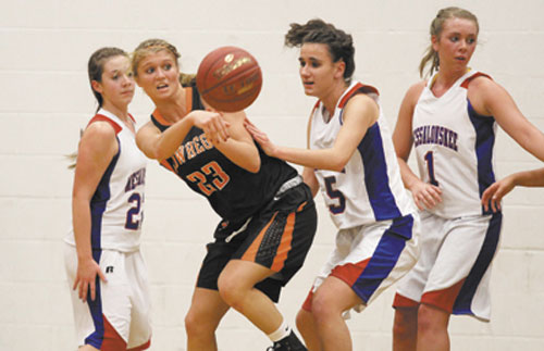 TIME TO PASS IT ON: Skowhegan Area High School’s Adriana Martineau looks to pass the ball to Natasha Thompson (not shown) while being defended by Messalonskee High School’s Rachael Wacome during first-half action in Oakland on Friday night.