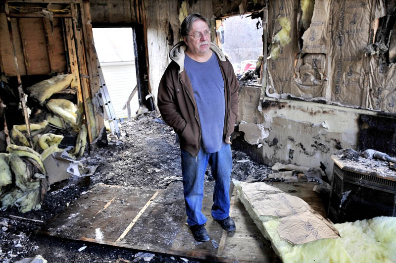 DAMAGE: Victor Carrigan speaks from a room in his apartment building in Anson that was seriously damaged by fire on Monday evening. Carrigan said he plans to rebuild the structure.