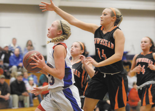 JUST OUT OF REACH: Messalonskee High School’s Mikayla Turner, left, puts up a shot just out of reach of Skowhegan Area High School’s Amanda Johnson during first-half action Friday night in Oakland.