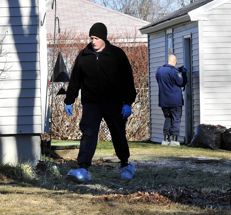 LOOKING FOR CLUES: Maine State Police investigators look for clues at the home and garage at 29 Violette Ave. in Waterville on Tuesday where 20-month-old Ayla Reynolds lived and disappeared last Friday.