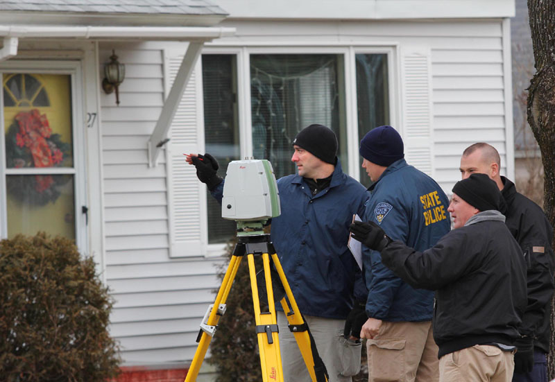 Photo by Jeff Pouland CONTINUING THE INVESTIGATION: Standing in a neighbor's yard, authorities continue their investigation into the disappearance of Ayla Reynolds near her home on Violette Avenue in Waterville on Friday.