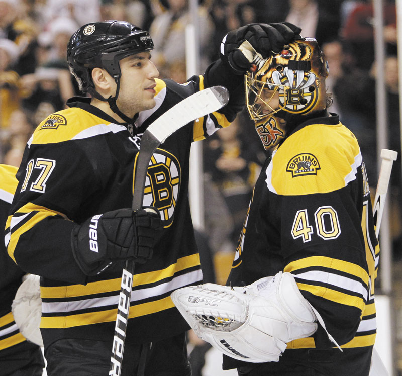 ON A ROLL: After a slow start to their season, the Boston Bruins have won 20 of their last 23 games. Milan Lucic, left is part of an offense that has scored an NHL-best 119 goals, while goalie Tuukka Rask, right, is part of one of the top goaltending tandems in the league, along with Tim Thomas.