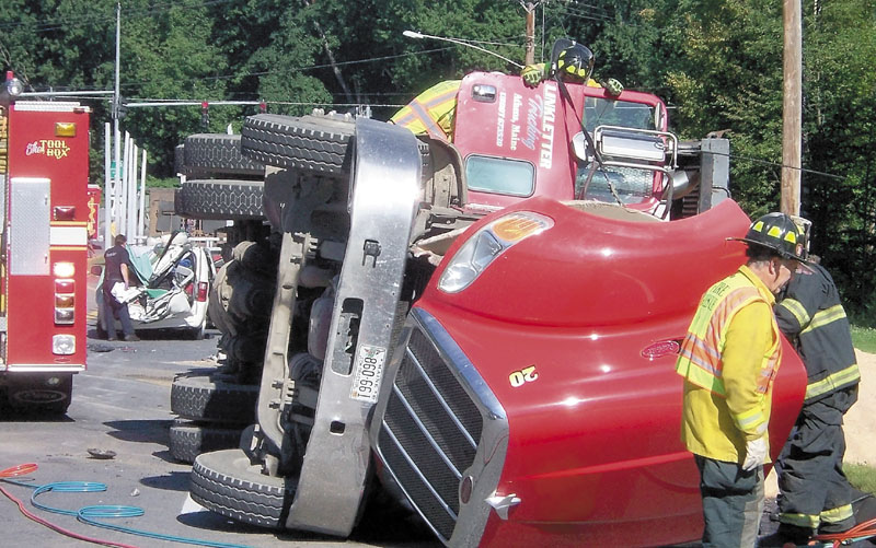 DEADLY CRASH: Emergency responders work at the scene of a fatal crash involving a tractor-trailer and a minivan Aug. 17 in Farmington. Franklin County authorities said Tuesday that the driver of the truck, Charles Willey, 53, of Dexter, will not face charges for the incident.