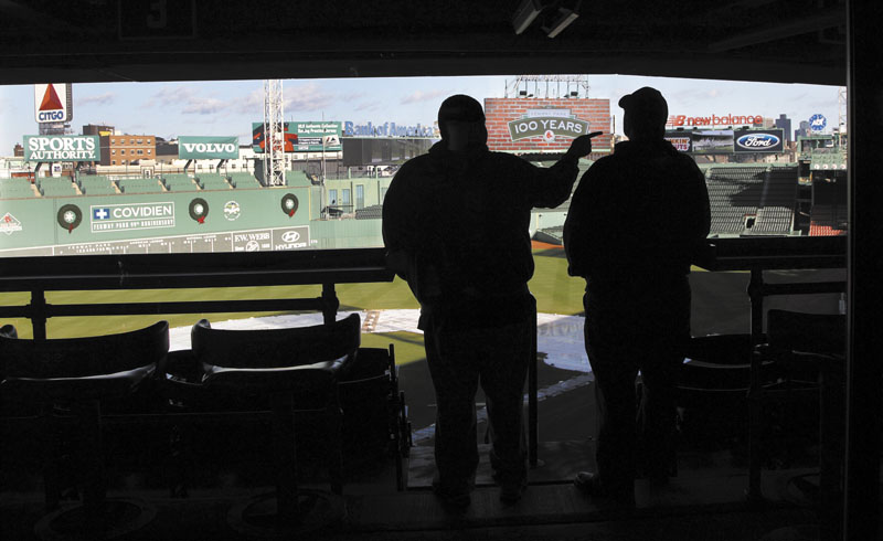 NICE DAY AT THE PARK: Two fans look out over the field at Fenway Park in Boston on Thursday at a news conference announcing upcoming events to celebrate the 100th anniversary of Fenway Park, the oldest operating Major League Baseball park in the United States.