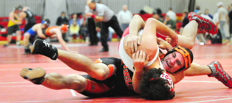 TAKEDOWN: Winslow’s Bryan Robbins, back, wrestles with Cony’s Cody Geroux in a 152-pound match during the Cony Duals on Tuesday at Cony High School in Augusta.