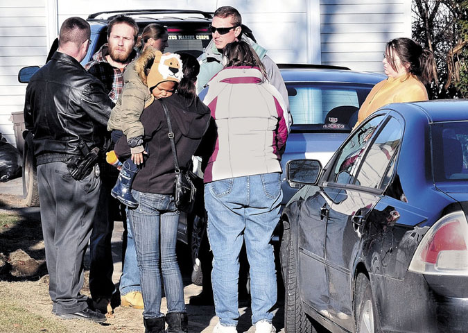 Maine State Police Detective Christopher Tupper, left, and Waterville Detective Lincoln Ryder, at right, question Justin DiPietro after he arrived at his home on Violette Avenue in Waterville on Sunday as an extensive search was under way at his home and the neighborhood for his 20-month-old daughter, Ayla Reynolds.