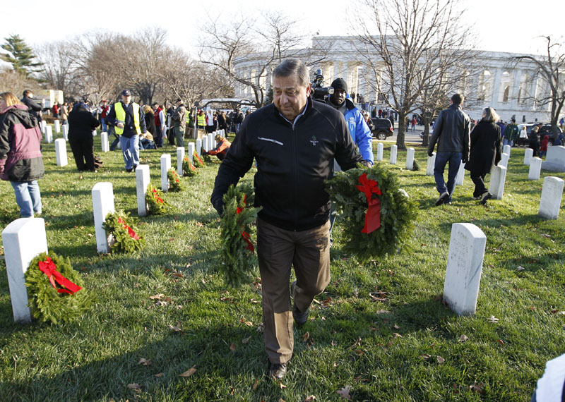 DOING HIS PART: Maine Gov. Paul LePage places wreaths Saturday at Arlington National Cemetery in Washington. The event was part of Wreaths Across America Day, which began 20 years ago when Karen and Morrill Worcester used wreaths from their Harrington-based company to honor American veterans.