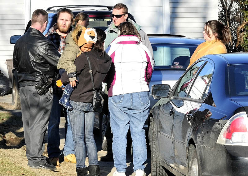 DESPAIR: Maine State Police Detective Christopher Tupper, left, and Waterville Detective Lincoln Ryder, at right, question Justin DiPietro after he arrived at his home on Violette Ave. in Waterville on Sunday as an extensive search was underway at his home and the neighborhood for his 20- month- old daughter Ayla Reynolds who has been missing since Friday.