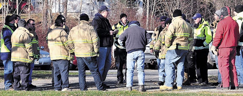 Staff photo by David Leaming COMMAND: Waterville Fire Chief Dave LaFountain, center, direct firefighters before an extensive search Sunday for missing 20-month-old Ayla Reynolds near her home on Violette Avenue in Waterville.