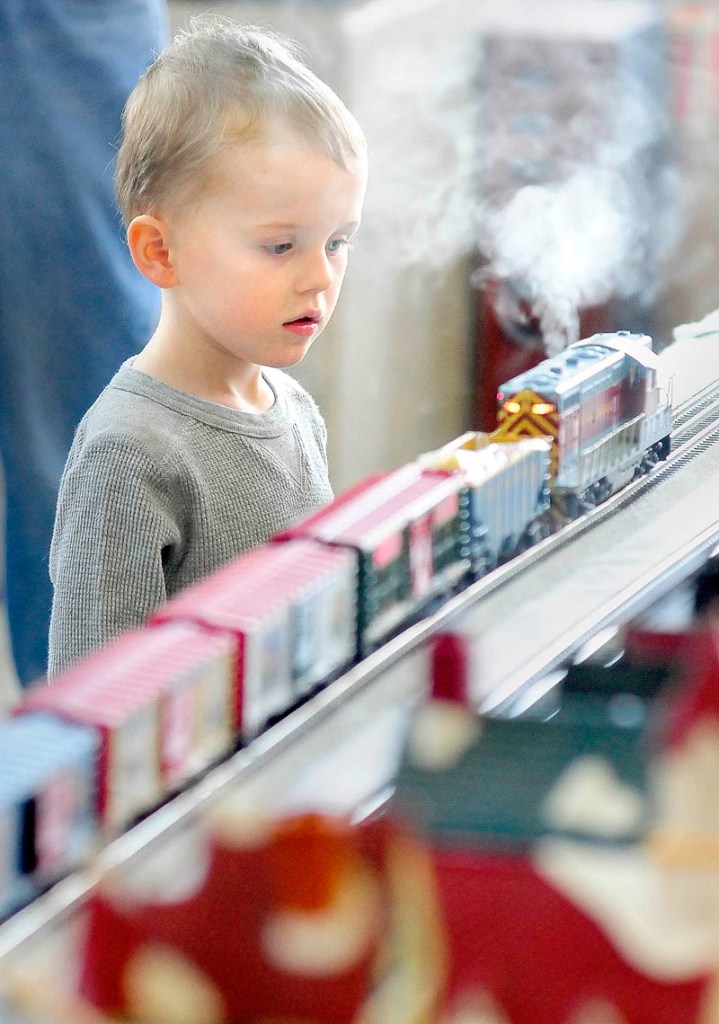THE POLAR EXPRESS: Ethan Post, 3, of Sidney, watches a smoking locomotive go past him Friday afternoon outside the Maine State Museum in Augusta. The Great Falls Model Railroad Club of Auburn and Augusta’s Maine 3-Railers will display their trains in the Cultural Building atrium again from 10 a.m. to 3 p.m. today. Museum admission is free. It is located at 230 State St., beside the State House.