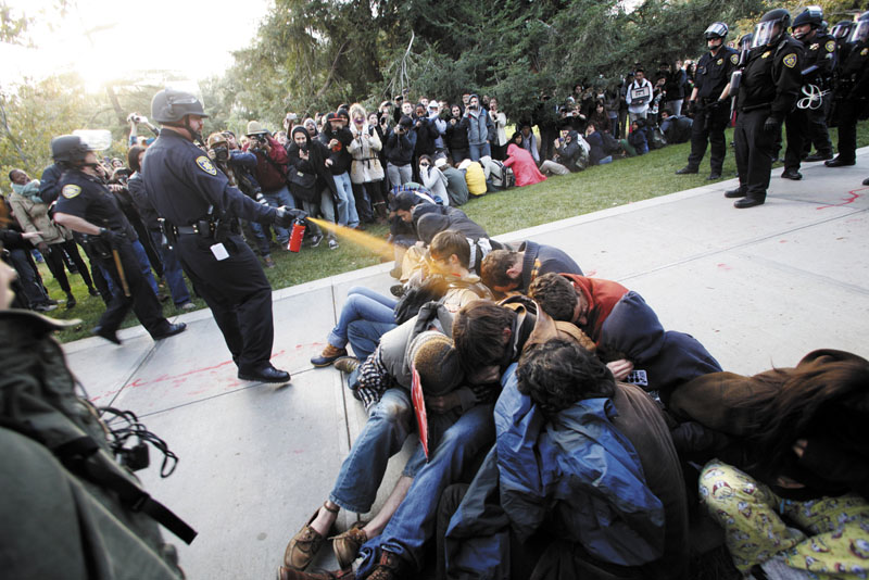 University of California, Davis, police Lt. John Pike uses pepper spray in November to move Occupy protesters while blocking their exit. Most Occupy protests across the nation have departed, but lawsuits about treatment remain.