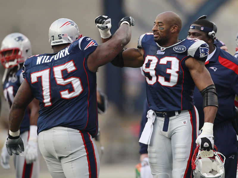 New England's Vince Wilfork and Andre Carter celebrate during the Patriots' win over the Colts on Sunday.