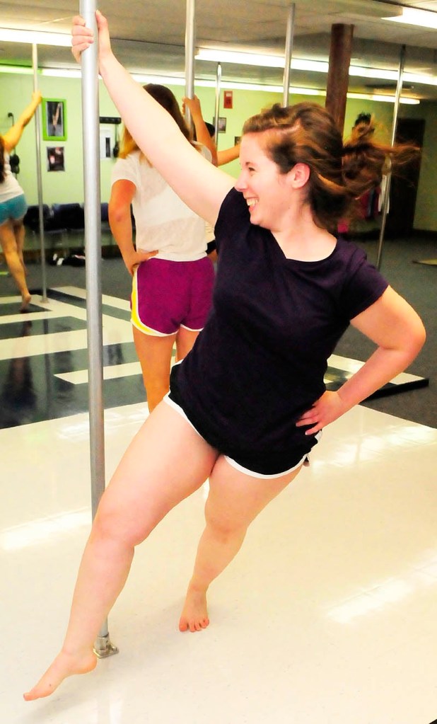 Brittany Rogers circles the pole during a class on Wednesday night at Heaven-Lee Heights Inc. at 553 Maine Ave., Farmingdale.