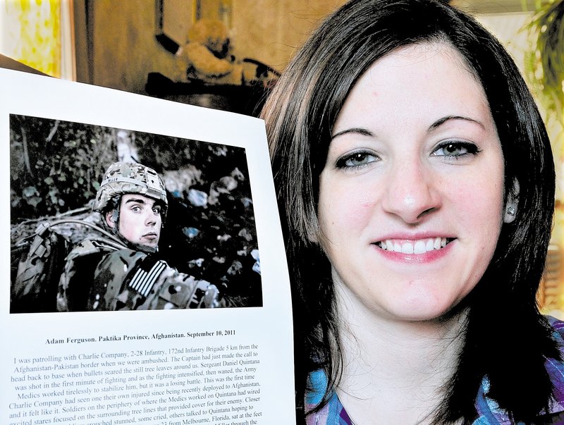 Brittany Miller poses with a Time magazine photograph of her husband, Michael, while he served in the U.S. Army in Afghanistan. It was chosen as one of Time's Top 10 Photos of 2011.