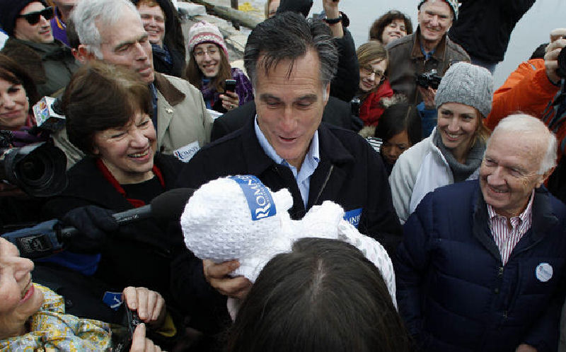 Republican presidential candidate former Massachusetts Gov. Mitt Romney holds up 2-month-old Anne Martin, of Portsmouth, N.H., during a campaign stop.