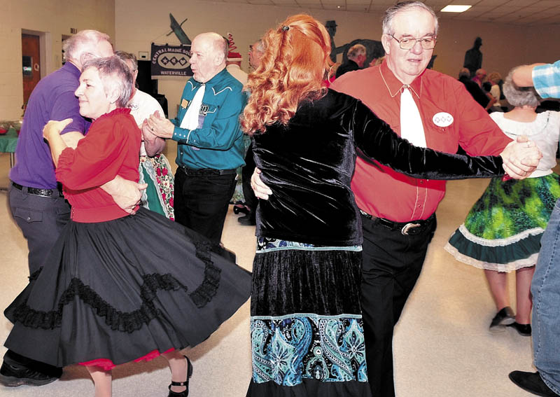 Barb Gilbert, left, of Winslow and her husband Dick, far right, dance during a recent square dance at the Waterville Junior High School.