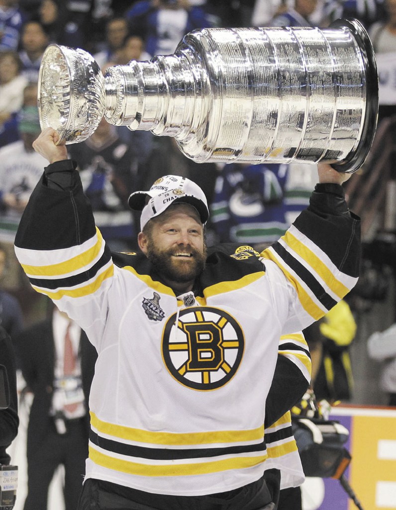 THE CHAMPS: Boston Bruins goalie Tim Thomas hoists the Stanley Cup after the Boston Bruins beat the Vancouver Canucks 4-0 in Game 7 of the Stanley Cup Finals on June 15 in Vancouver, British Columbia.