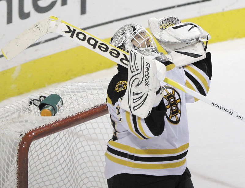 A SHUTOUT: Tim Thomas celebrates after stopping 31 shots in the Boston Bruins’ 6-0 win over the Philadelphia Flyers on Saturday in Philadelphia.