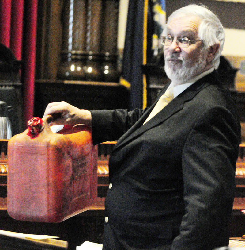 Raymond Bellavance Jr. 's defense attorney Andrews Campbell,holds up a gas can found the fire scene while he makes his closing arguments in his client's arson trial this morning in Kennebec County Superior Court in Augusta. Bellavance, 50, of Winthrop, is charged in the June 3, 2009, fire at the Grand View Topless Coffee Shop.