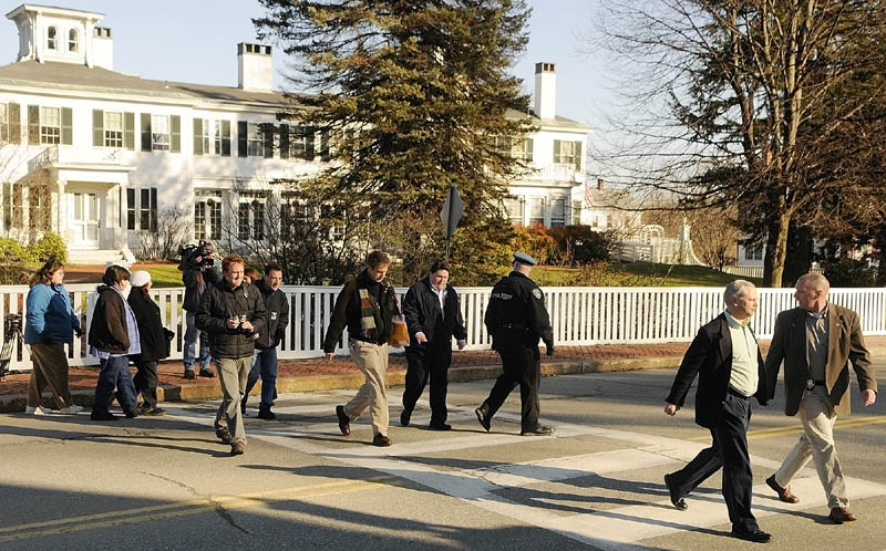 MEETING WITH THE GOVERNOR: Four members of a group protesting outside the Blaine House are escorted by law enforcement officers and Governor's Office staff across the street to meet with Gov. Paul LePage on Saturday morning in Augusta.