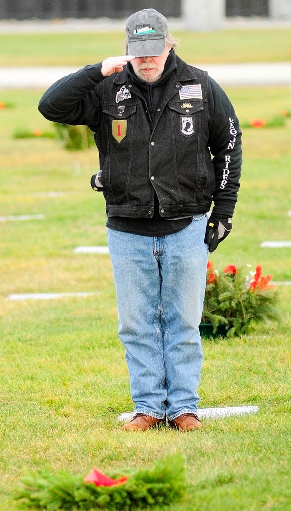 SALUTE: Gary Orcutt, of Norridgewock, salutes after placing a wreath on a veteran’s grave Saturday at Maine Veterans’ Memorial Cemetery on Mount Vernon Road in Augusta.