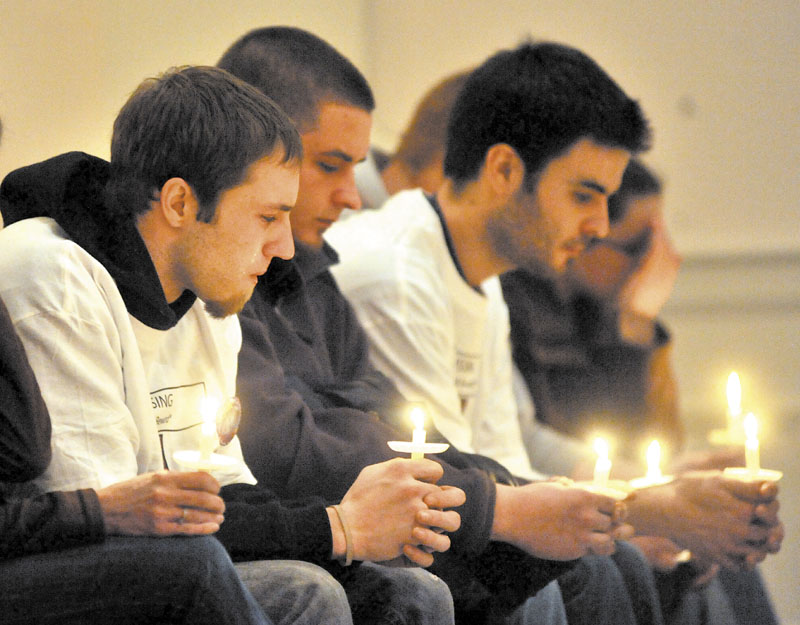VIGIL FOR AYLA: Tears stream down the face of Justin DiPietro, left, during a candlelight vigil for his missing daughter, Ayla Reynolds, at First Congregational Church in Waterville on Tuesday.