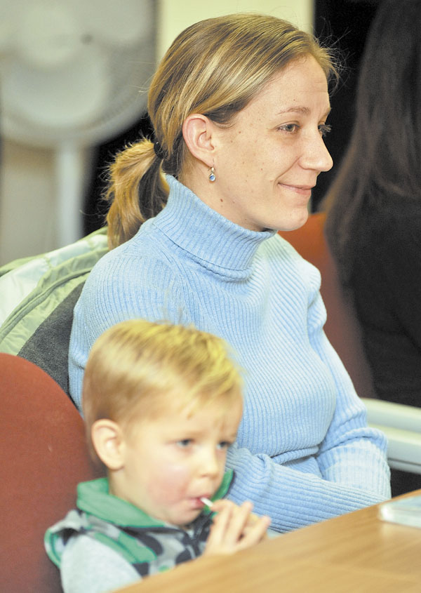 LIHEAP: Lori Williams and her son Ethan Thomas Williams, 2, listen to U.S. Sen. Olympia Snowe during a discussion about heating assistance for low-income families at Kennebec Valley Community Action Program offices in Waterville Thursday.