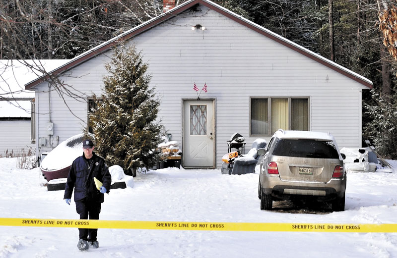 SHOOTING: Maine State Police Detective Bryant Jacques leaves the home while investigating the scene where a 22-year-old man was shot early Tuesday morning on Whitehouse Road in Vassalboro.