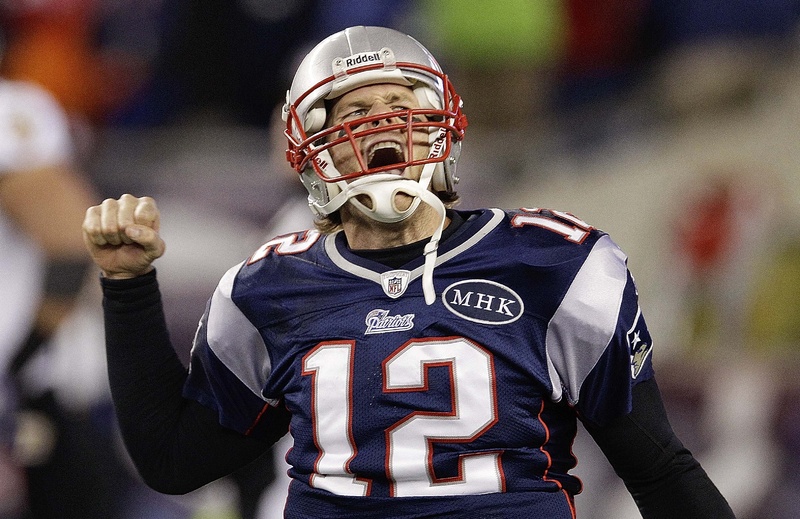 New England Patriots quarterback Tom Brady celebrates after scoring a touchdown during the second half of the AFC Championship NFL game against the Baltimore Ravens Sunday. The Patriots won, 23-20. playoff playoffs