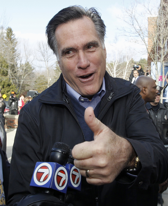 Republican presidential candidate Mitt Romney campaigns today outside a polling station in Manchester, N.H.