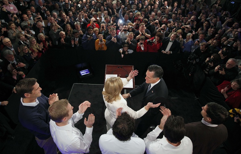 Former Massachusetts Gov. Mitt Romney reaches for his wife Ann as his sons, Josh, Ben, Craig, Tagg and Matt, left to right, applaud during the Romney for President rally at Southern New Hampshire University in Manchester, N.H., on Tuesday, when Romney won the state's GOP primary.