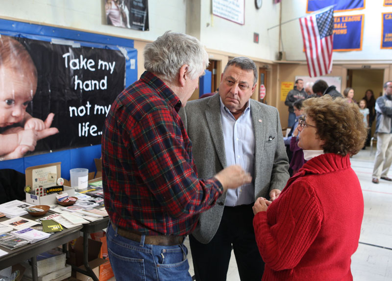 Gov. Paul LePage, center, speaks with Rep. Paul Davis, R-Sangerville, left, and his wife Patty Davis, rightt, on Saturday at an anti-abortion rally in Augusta as part of the annual "Hands Around the Capitol Rally and March."