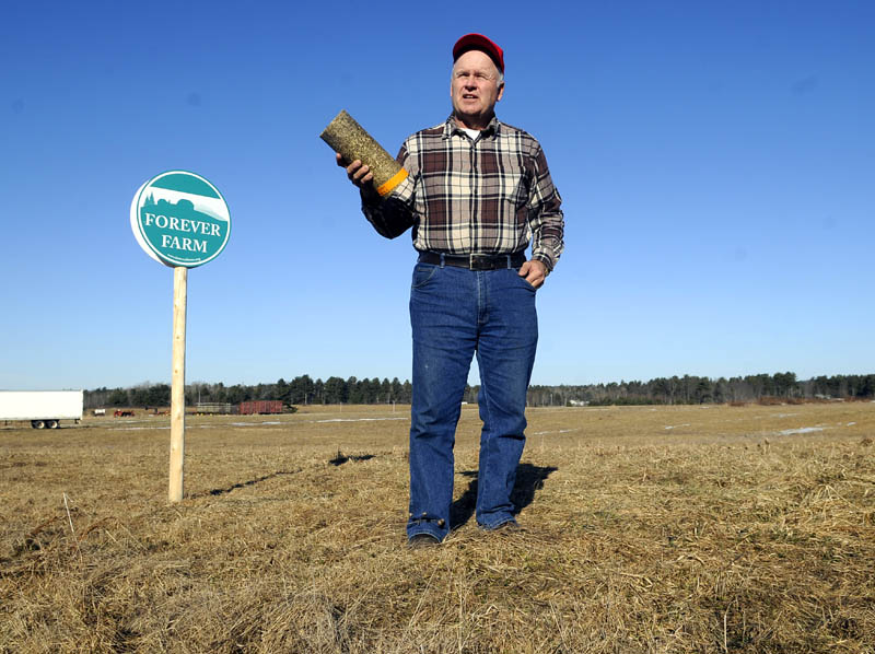 HEATING WITH HAY: Vassalboro farmer Peter Bragdon hopes to preserve farmland by producing logs from hay for home heating use.