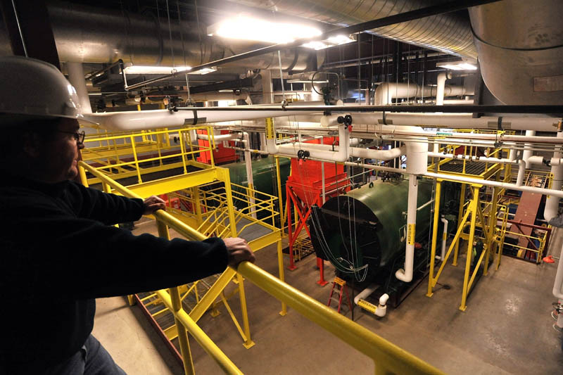 WATCHING: Tony Tuell, Supervisor of Mechanical and Electrical Services, stands on an observation deck at the newly built biomass plant at Colby College.