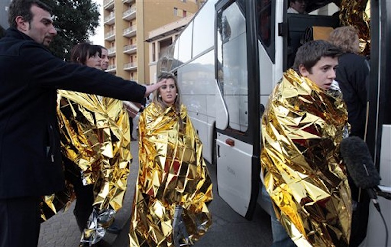 Passengers of the luxury ship that ran aground off the coast of Tuscany board a bus in Porto Santo Stefano, Italy. (AP Photo/Gregorio Borgia)