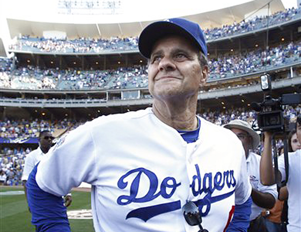 In this Oct. 3, 2010, photo, Joe Torre, then-manager of the Los Angeles Dodgers, watches a video tribute during a farewell ceremony for him in Los Angeles.