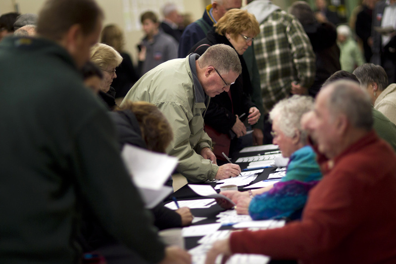 Voters sign in to caucus at Point of Grace Church tonight in Waukee, Iowa.