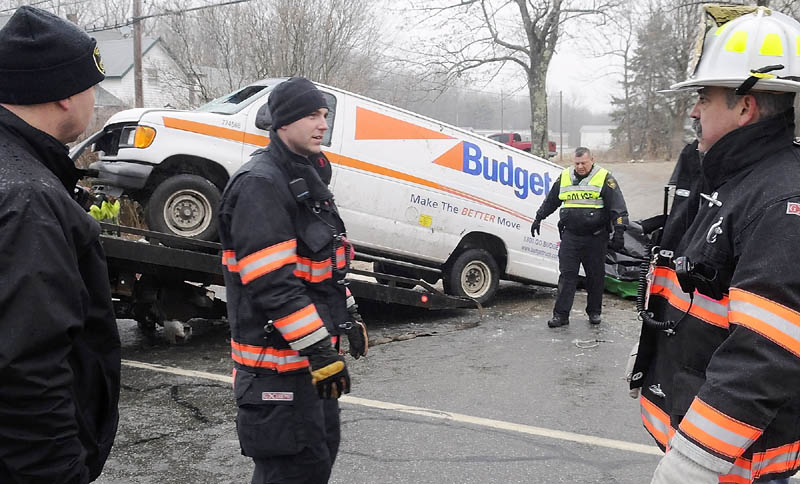 TWO DEAD IN ACCIDENT: Gardiner police and firefighters remove a van that rolled over Saturday morning and claimed the lives of two men and injured a third on the ice-covered U.S. Route 201 in Gardiner. The accident occurred after 8 a.m., according to Gardiner Police Chief James Toman.