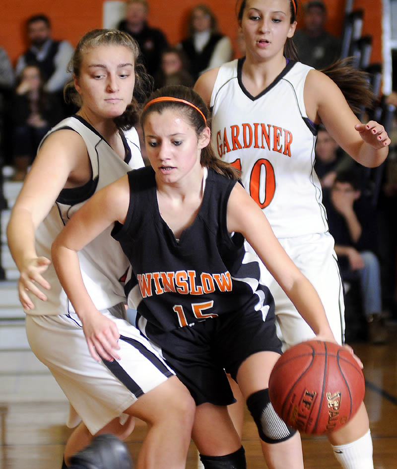 TOUGH TO GET BY: Gardiner Area High School’s Ally Day, left, and Kate McAllister, right, box in Winslow High School’s Devin Fitzgibbons during a game Tuesday in Gardiner.