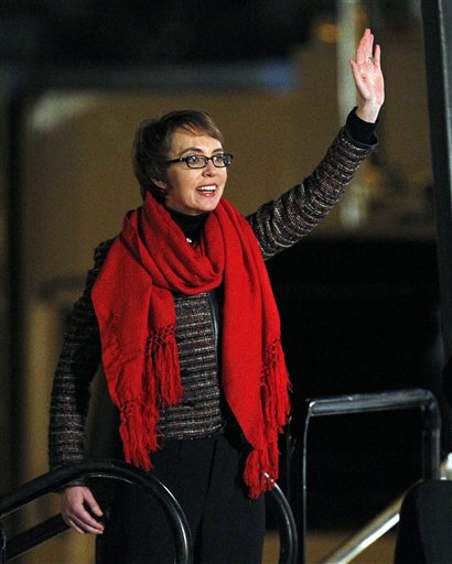 Giffords waves at the start of the Jan. 8 memorial vigil remembering the victims and survivors one year after the Arizona congresswoman was wounded in a shooting that killed six in Tucson, Ariz.