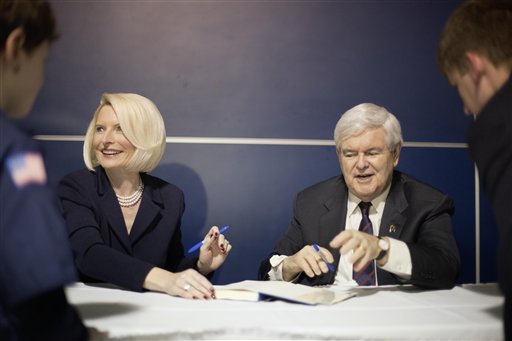 Republican presidential candidate Newt Gingrich and his wife Callista sign autographs Friday at a campaign rally aboard the USS Yorktown in Mt. Pleasant, S.C.