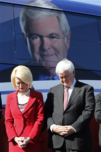 Newt Gingrich, with his wife Callista, bow their heads in prayer during a campaign event in Lady Lake, Fla., on Sunday.