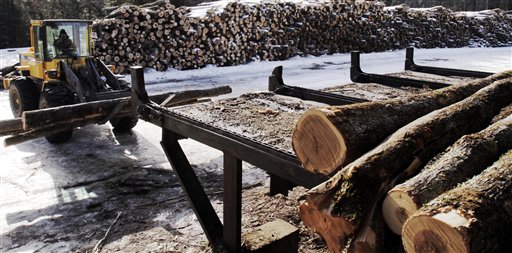 Logs are moved around the wood yard at Southern Maine Firewood in Gorham recently. The company sold 3,200 cords last year, up from 2,600 in 2010.