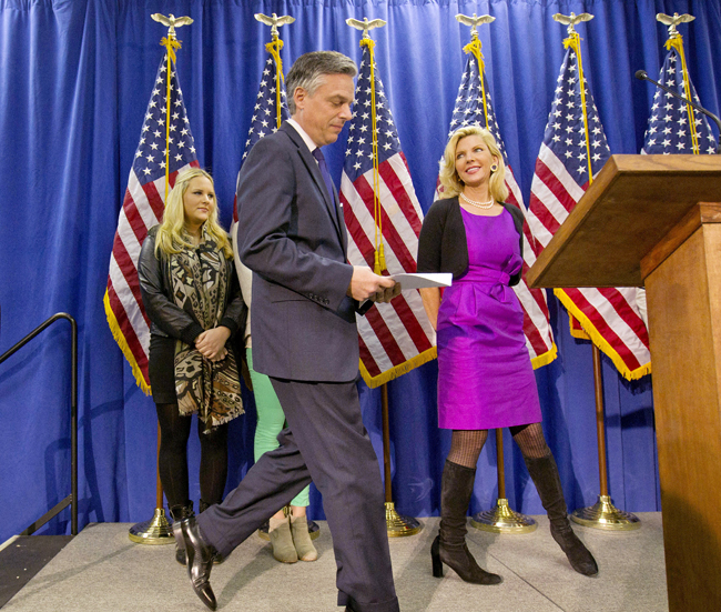 Former Utah Gov. Jon Huntsman steps to the podium today to announce his withdrawal from the presidential race and endorsement for former Massachusetts Gov. Mitt Romney, as wife Mary Kaye, right, and daughter Elizabeth, left, look on.