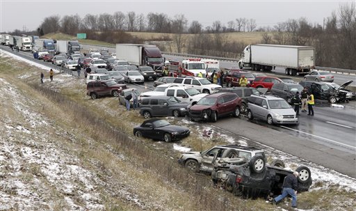 Emergency crews work the scene after a crash along Interstate 75 that involved 41 cars during snowy conditions Monday near Dry Ridge, Ky. No life-threatening injuries were reported. The road reopened around 3 p.m. on Monday after being shut down for about three hours from the pileup.