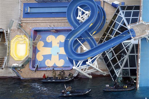 Italian Navy scuba divers work next to the cruise ship Costa Concordia off the island of Giglio on Sunday.
